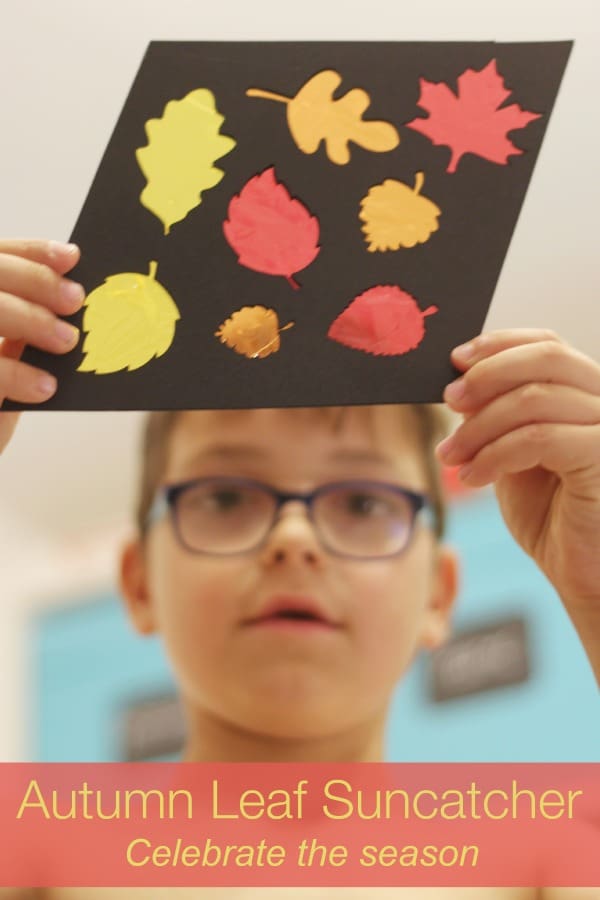 Autumn sun catcher. Make a beautiful cellophane sun catcher to celebrate fall. The black background really makes the autumnal colours pop. This is a super fun DIY craft activity for kids.