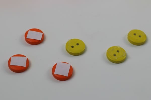 6 Orange and yellow buttons , the orange ones with double sided tape on the back