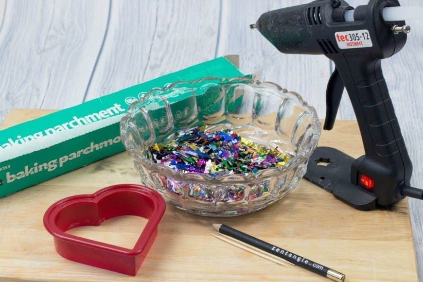 Hot Glue Gun Confetti Heart Cake Topper. This is a fab DIY craft to make a confetti heart, which is perfect as a cake topper for celebrations and if you only confetti one side they make a brilliant window cling. You could make any shape, letter, or number. You could even frame it as art instead of putting a toothpick in it as a cake topper