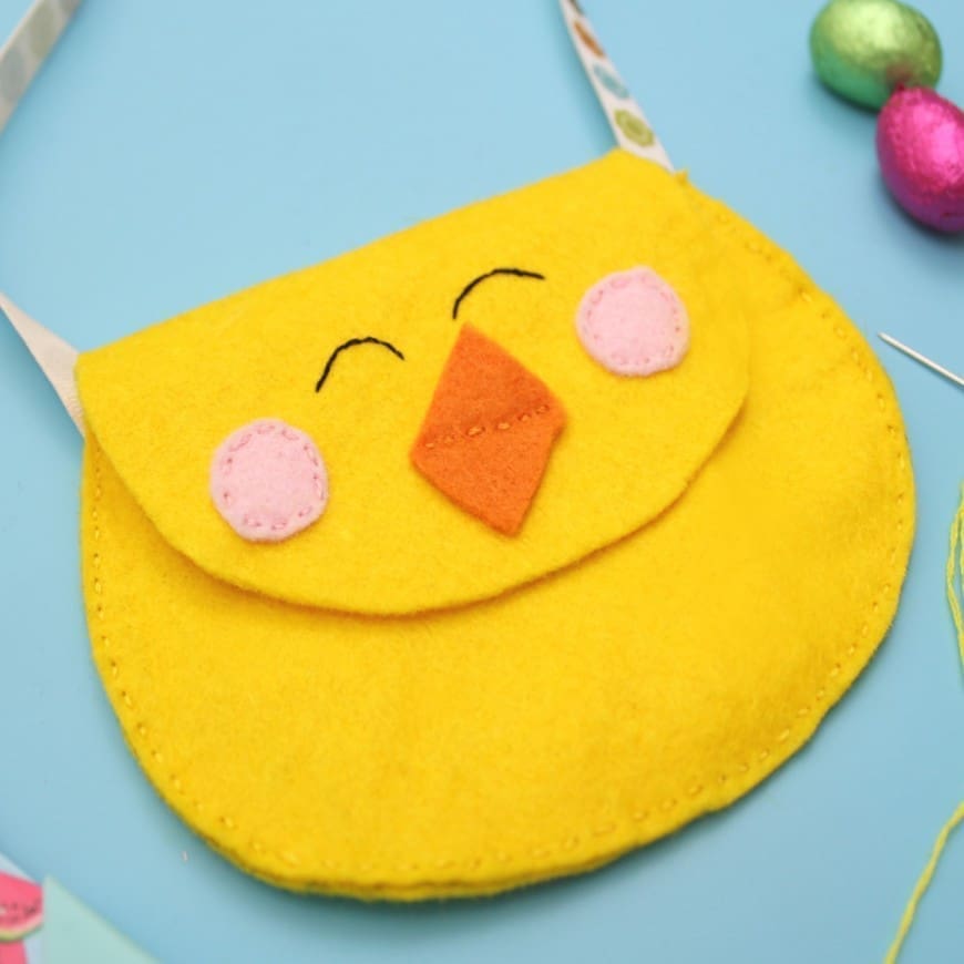 This cute felt chick purse is the perfect introduction in to sewing. A simple DIY craft sewing project to hold your kids Easter eggs this Spring.