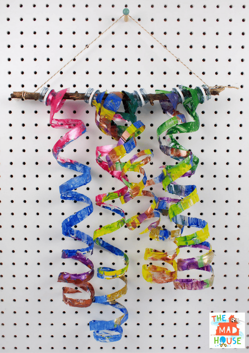 Upcycle plastic water bottles with this fantastic child-led process art activity to create a plastic bottle wind spiral mobile and plastic bottle sculpture.