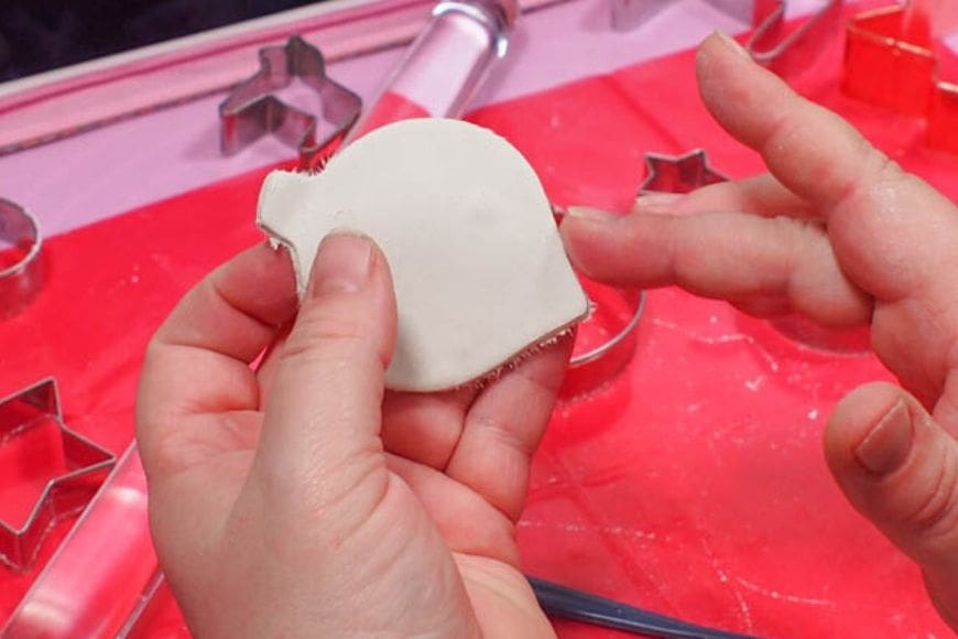 Smoothing the edges of Gold and White Air Drying Clay Christmas Decorations