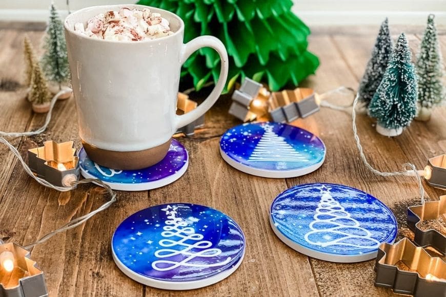 Stunning DIY Christmas Coasters using Cricut Infusible ink to create stunning and bright Christmas Tree silhouettes against a starry night sky.