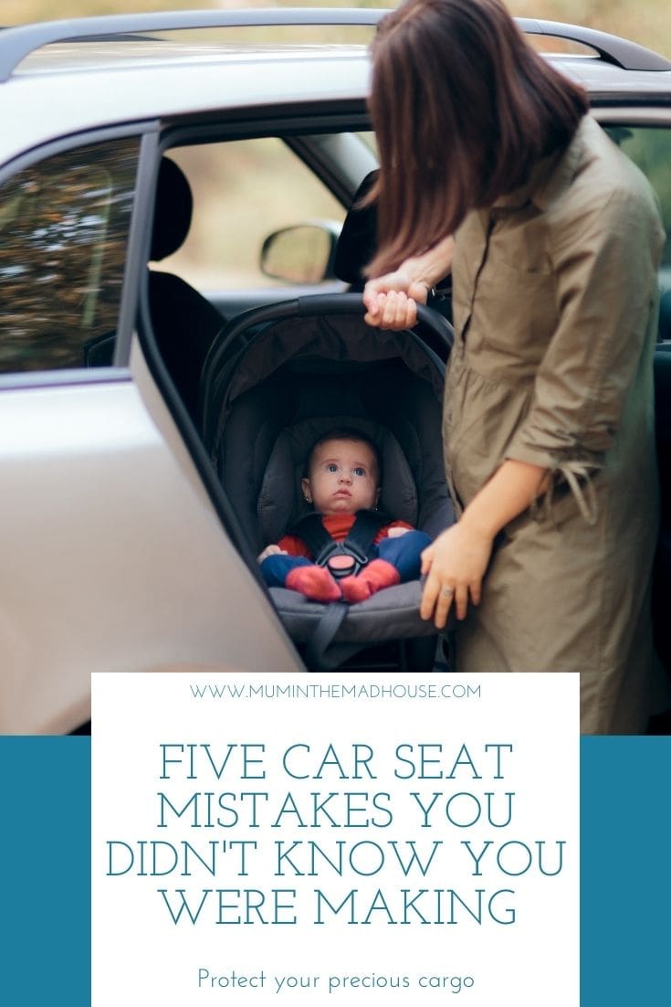Mum holding baby in car seat