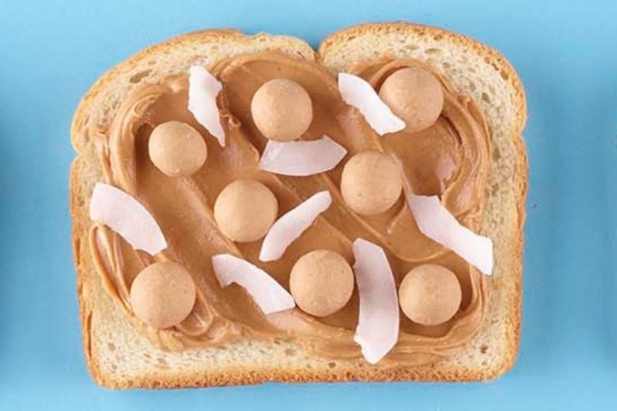 Double peanut butter on toast with coconut flakes