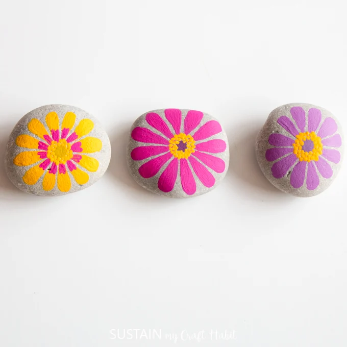 Zinnias painted on rocks