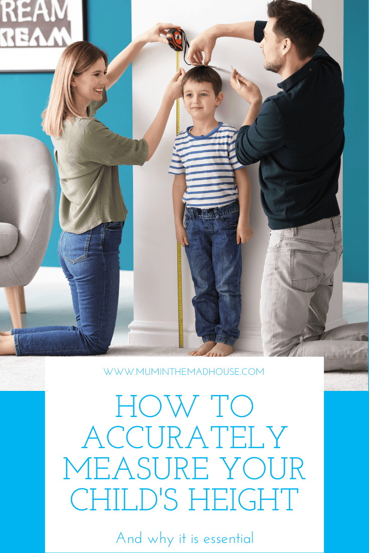 Parents measuring height of their son at home