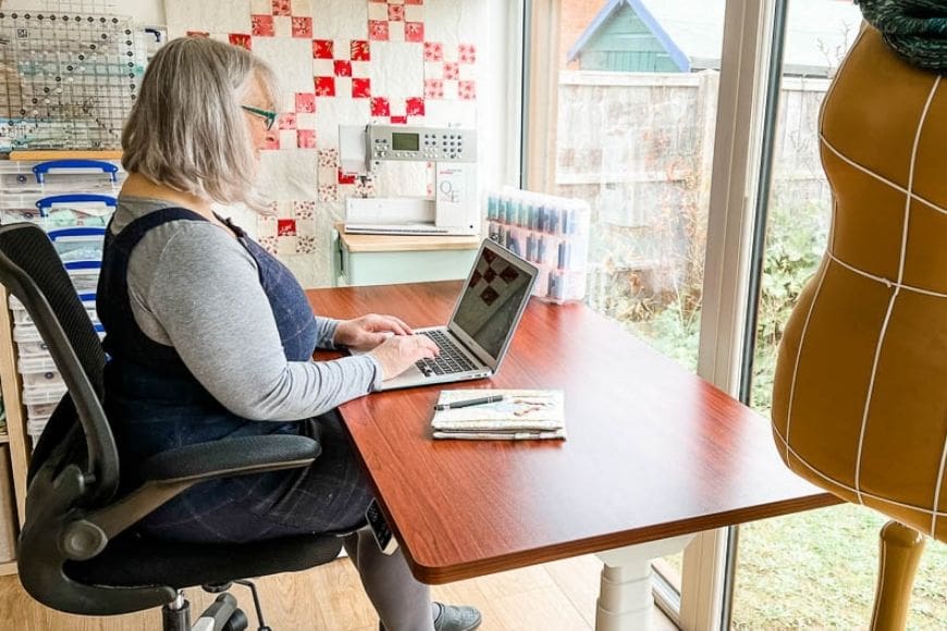 Sitting with laptop at an adjustable desk