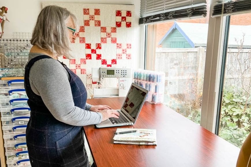 standing with a laptop at an adjustable desk