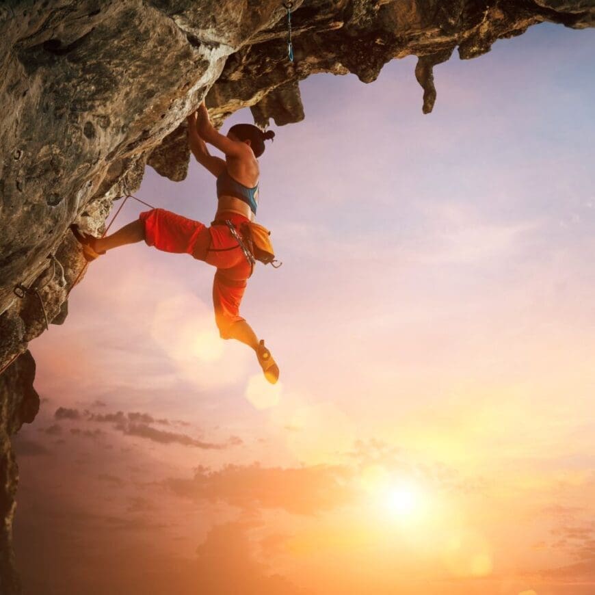 Women rock climbing an overhang