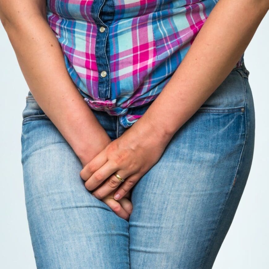 Woman with hands holding her crotch, she wants to to go to the toilet