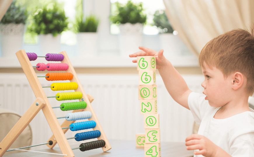 A toddler counting with blocks