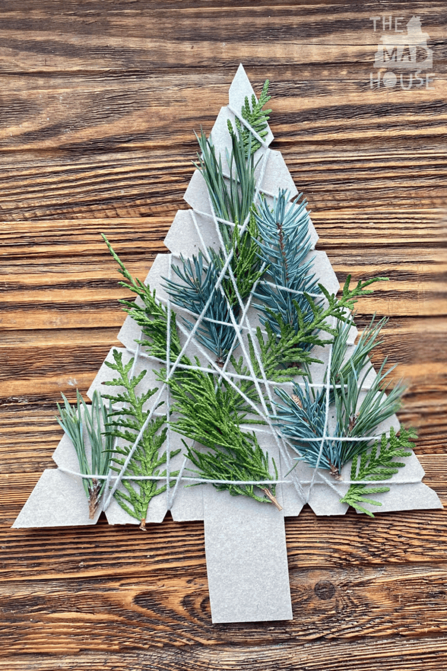 Engage your kids with this easy nature-inspired Christmas tree craft! Using cardboard, twine, and greenery, create beautiful handmade decor with a rustic holiday feel.