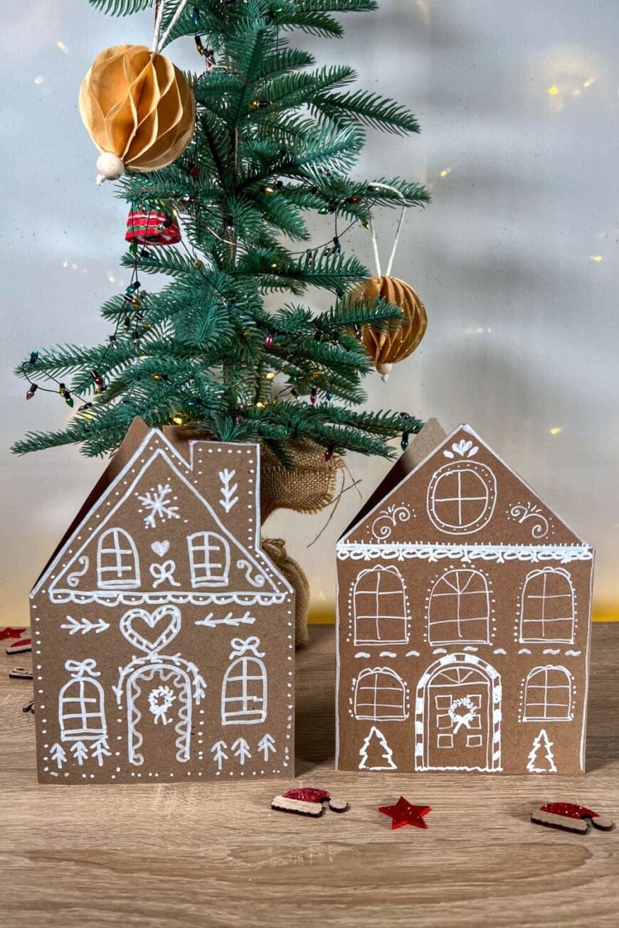 Create adorable Gingerbread House Christmas Cards with brown kraft card and white paint pens! Fun to make and perfect for sending holiday love to family and friends.