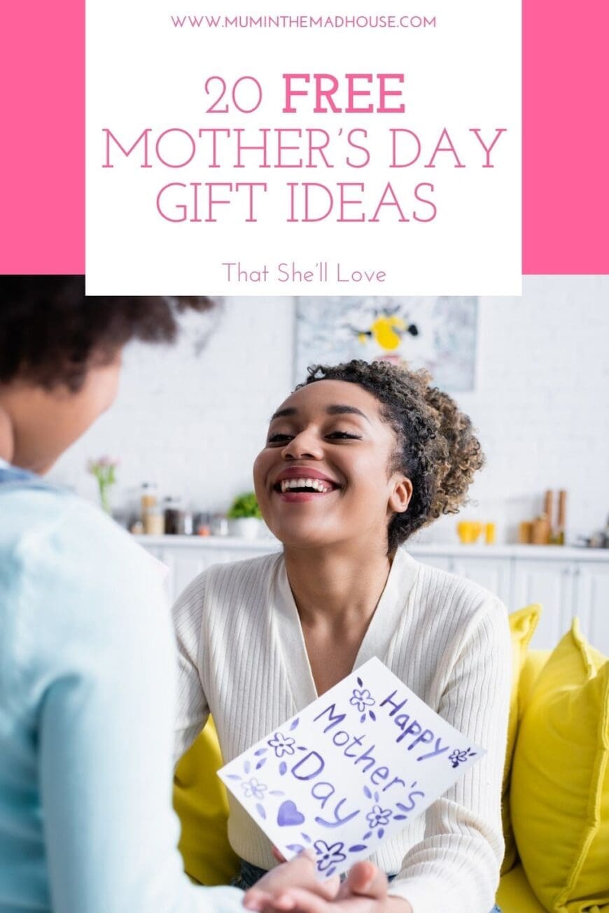 A joyful mother with curly hair smiles warmly as she receives a handmade Mother’s Day card from her child. The card, decorated with blue flowers and hearts, reads ‘Happy Mother’s Day’. The background features a cozy home setting with bright yellow cushions and soft natural lighting