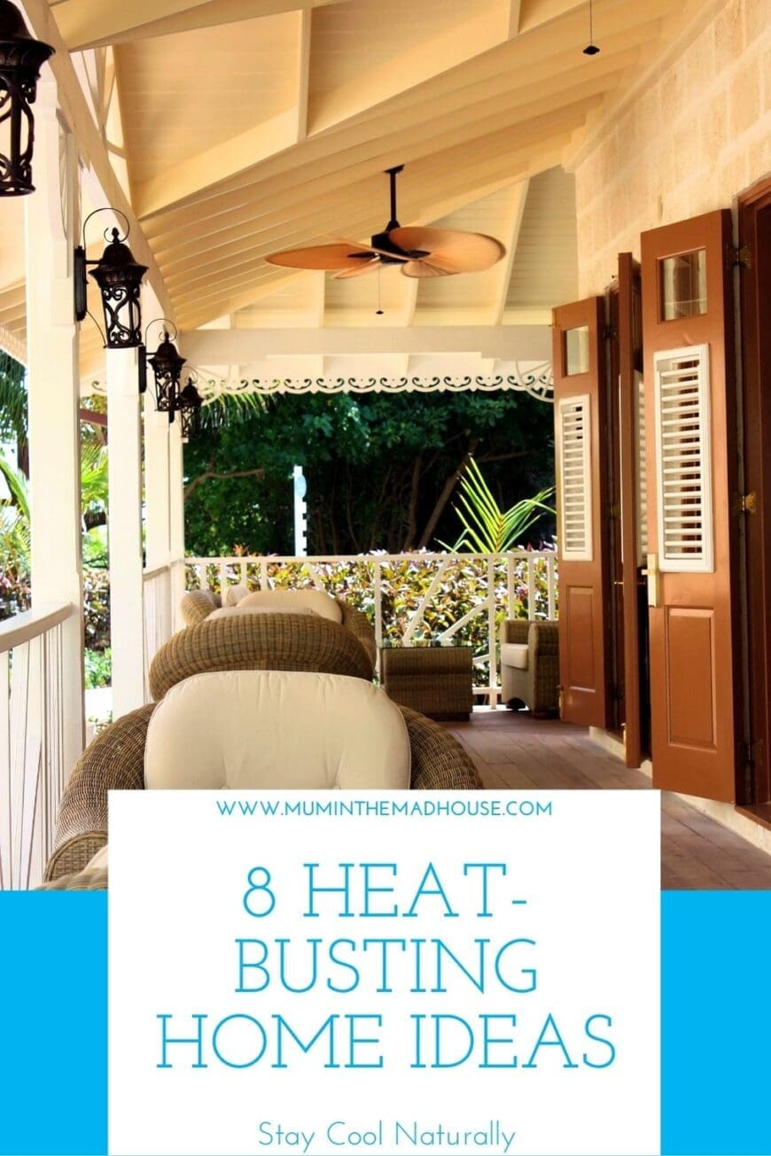 Covered veranda with wicker furniture and a tropical-style ceiling fan, surrounded by greenery, with text overlay: ‘8 Heat-Busting Home Ideas – Stay Cool Naturally’ from www.muminthemadhouse.com