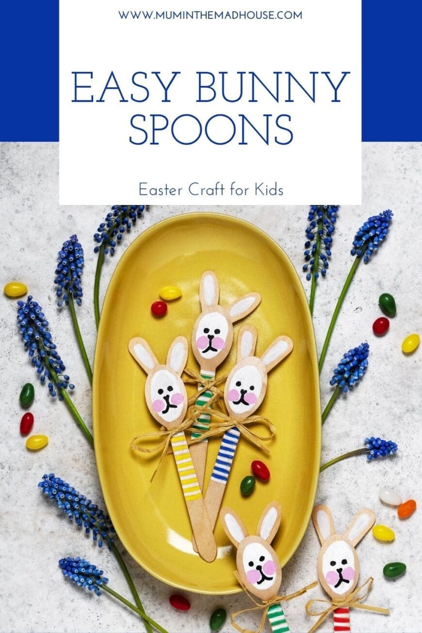 Flat lay of handmade wooden spoon bunnies with painted faces and colourful striped “jumpers,” each tied with a bow. Surrounded by blue spring flowers and jelly beans. Text overlay reads “DIY Wooden Spoon Bunnies – Fun & Simple Easter Activity.