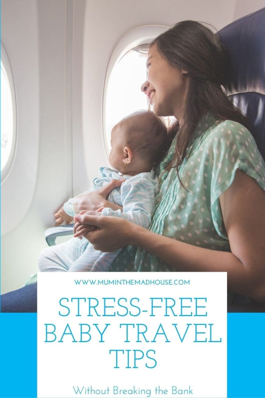 Mother holding her baby on an airplane, both looking peacefully out the window during a calm and stress-free flight.