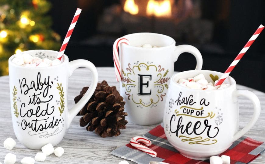 DIY Christmas mugs with painted snowflakes, names, and festive quotes
