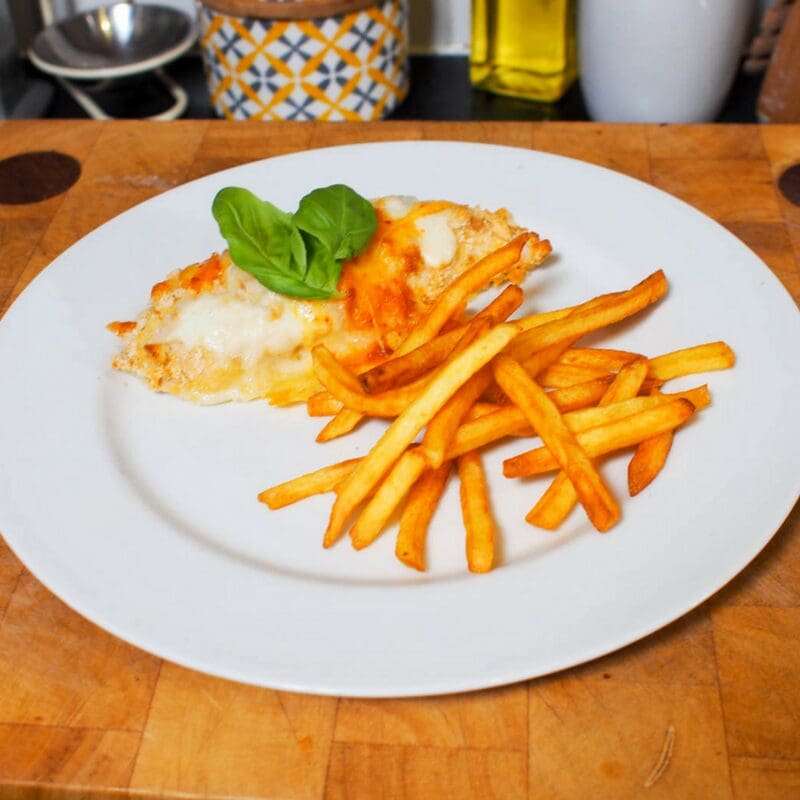 it consists of chicken in breadcrumbs topped with a white béchamel/Parmesan sauce and cheese