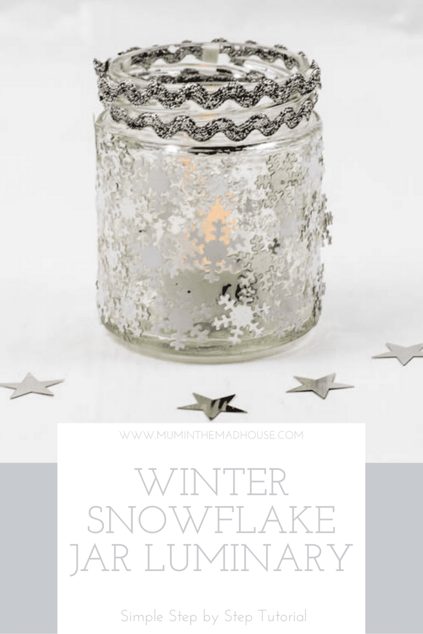 Glass jar with snowflake sequins on and two rows of silver rick rack on the top